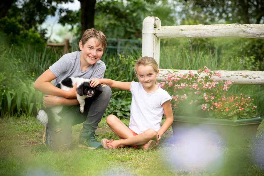 A boy and girl with a toy Spaniel